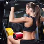 Woman exercising on weightlifting machine