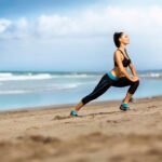 Attractive woman stretching on the beach